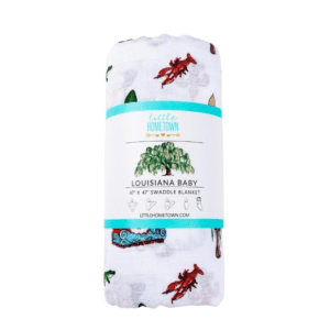 A white blanket with red lobster and green leaves on it.