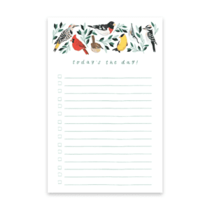 A notepad with birds and leaves on it.