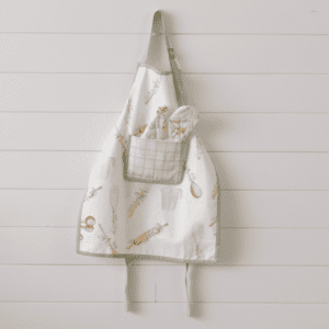 A white apron hanging on the wall