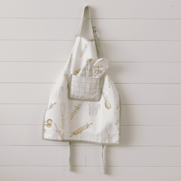 A white apron hanging on the wall