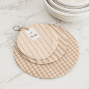 A wooden cutting board and two other wood plates.