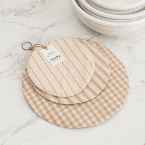 A wooden cutting board and two other wood plates.