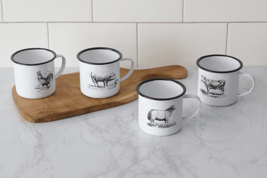 A group of four mugs sitting on top of a counter.