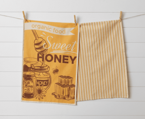 A towel with an image of honey and bees on it.