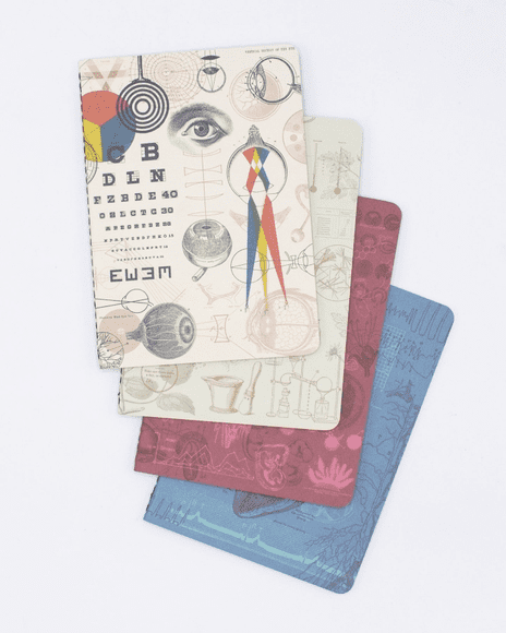 A set of four notebooks with different designs on them.