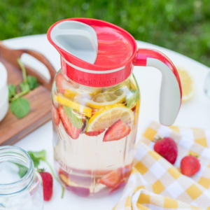 Red pitcher with lemon and strawberry infused water.