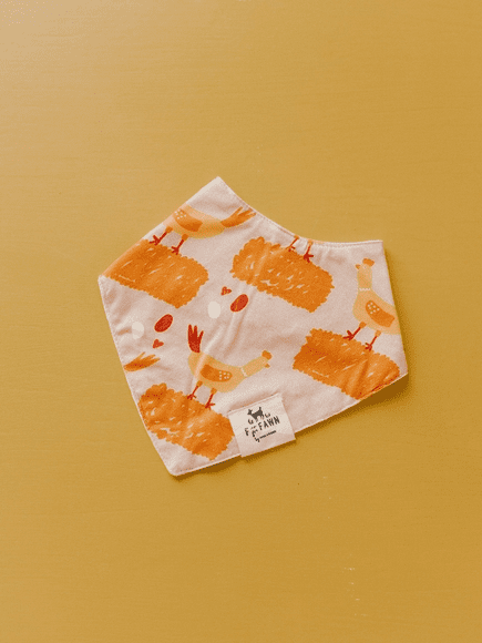 A white and orange bandana with candles on it.