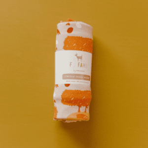 A roll of orange and white paper on a yellow background.