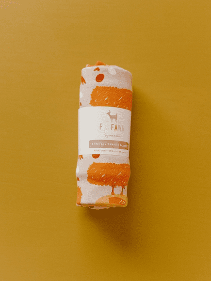 A roll of orange and white paper on a yellow background.