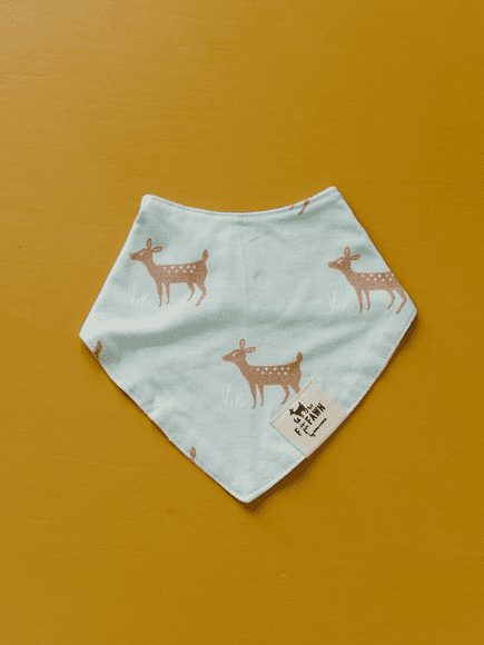 A blue bandana with brown deer on it