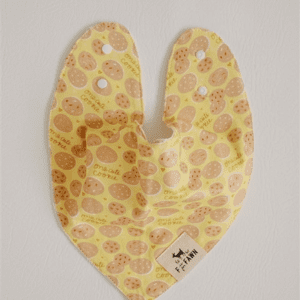 A yellow bib with brown spots on it.