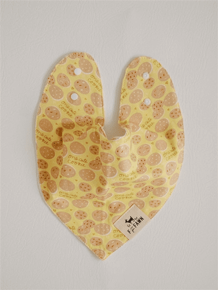 A yellow bib with brown spots on it.