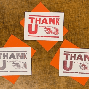 Three thank you cards sitting on top of a table.