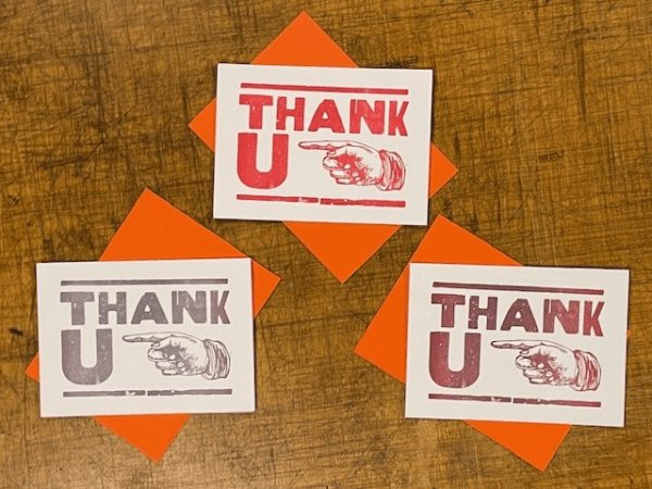 Three thank you cards sitting on top of a table.