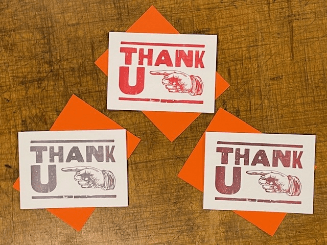 Three thank you cards sitting on top of a table.