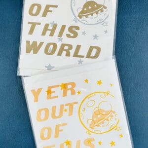 Two cards with "Yer Out Of This World" and a UFO.