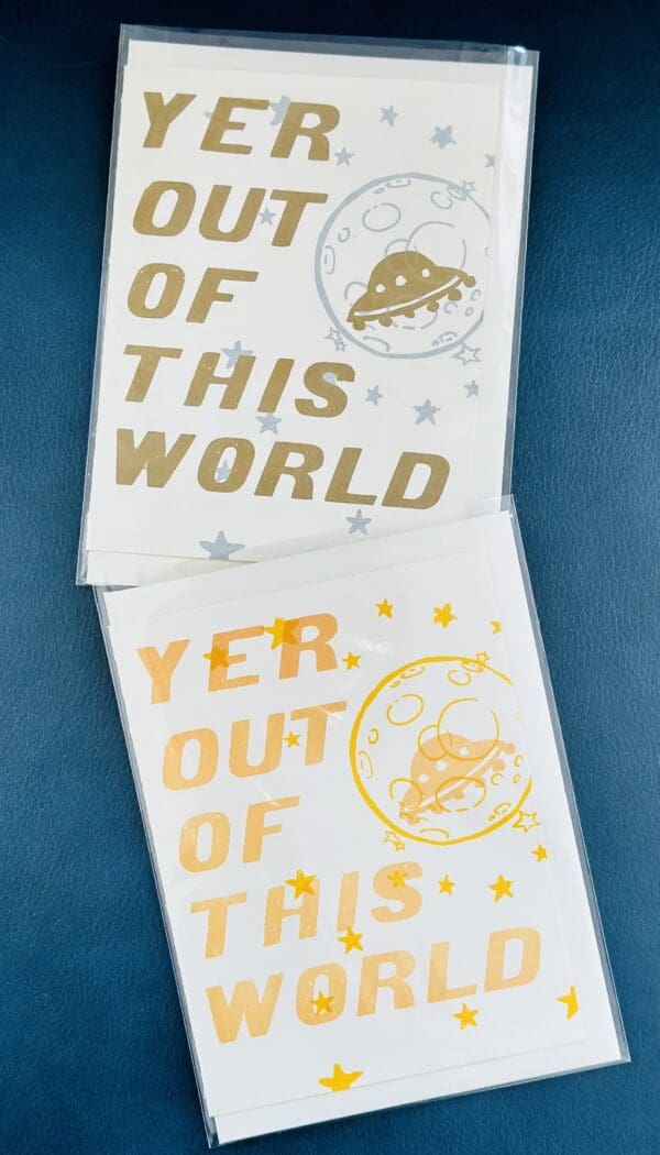 Two cards with "Yer Out Of This World" and a UFO.