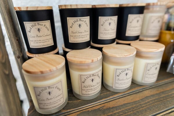 A row of candles on top of a wooden table.