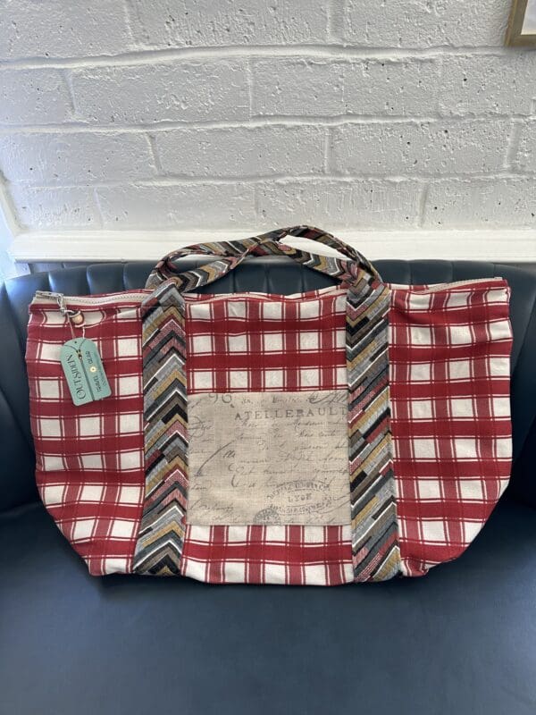 A red and white bag with a tie on it