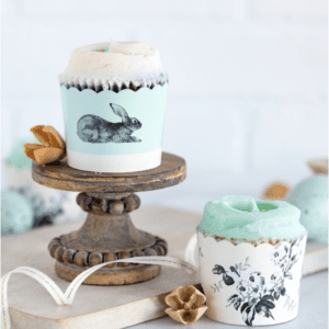 A cup cake on top of a wooden stand.