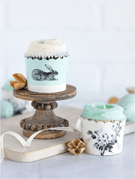 A cup cake on top of a wooden stand.