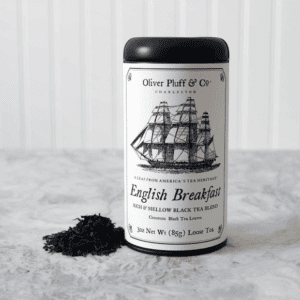 A black tea container sitting on top of a white table.