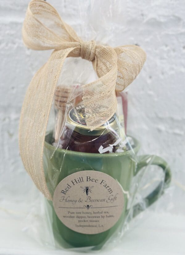 Green mug with honey and beeswax gift.