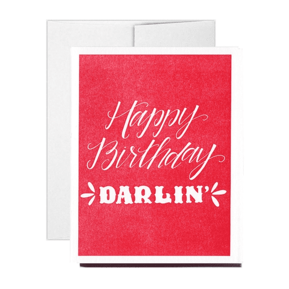 A red card with white lettering that says happy birthday darlin '.