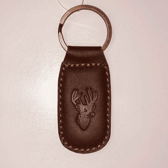 A brown leather key chain with an image of a deer.