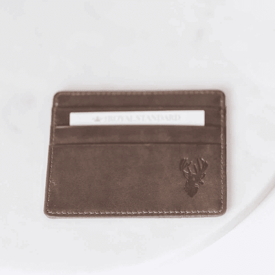 A brown wallet sitting on top of a table.