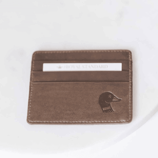 A brown card holder with an elephant on it.