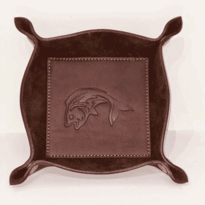 A brown leather tray with a fish design on it.