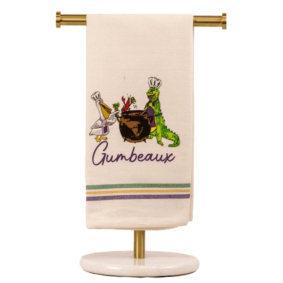 A towel on a stand with the word " gumbeaux " embroidered in it.