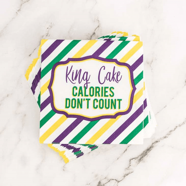 A close up of a paper napkin with the words " king cake calories don 't count ".