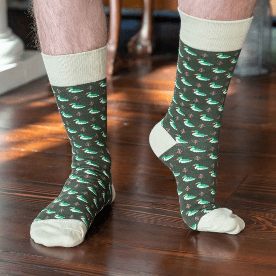 A person wearing green socks on the ground