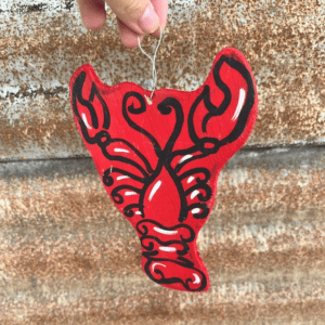 A red lobster ornament hanging on the wall.