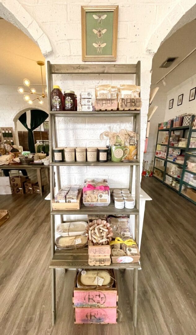 Wooden shelf with honey, candles, and gifts.