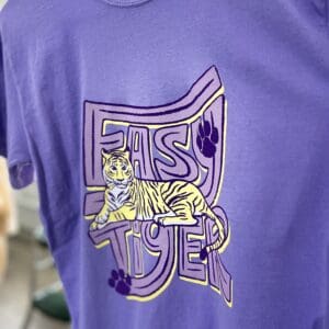 A purple shirt with a cat on it