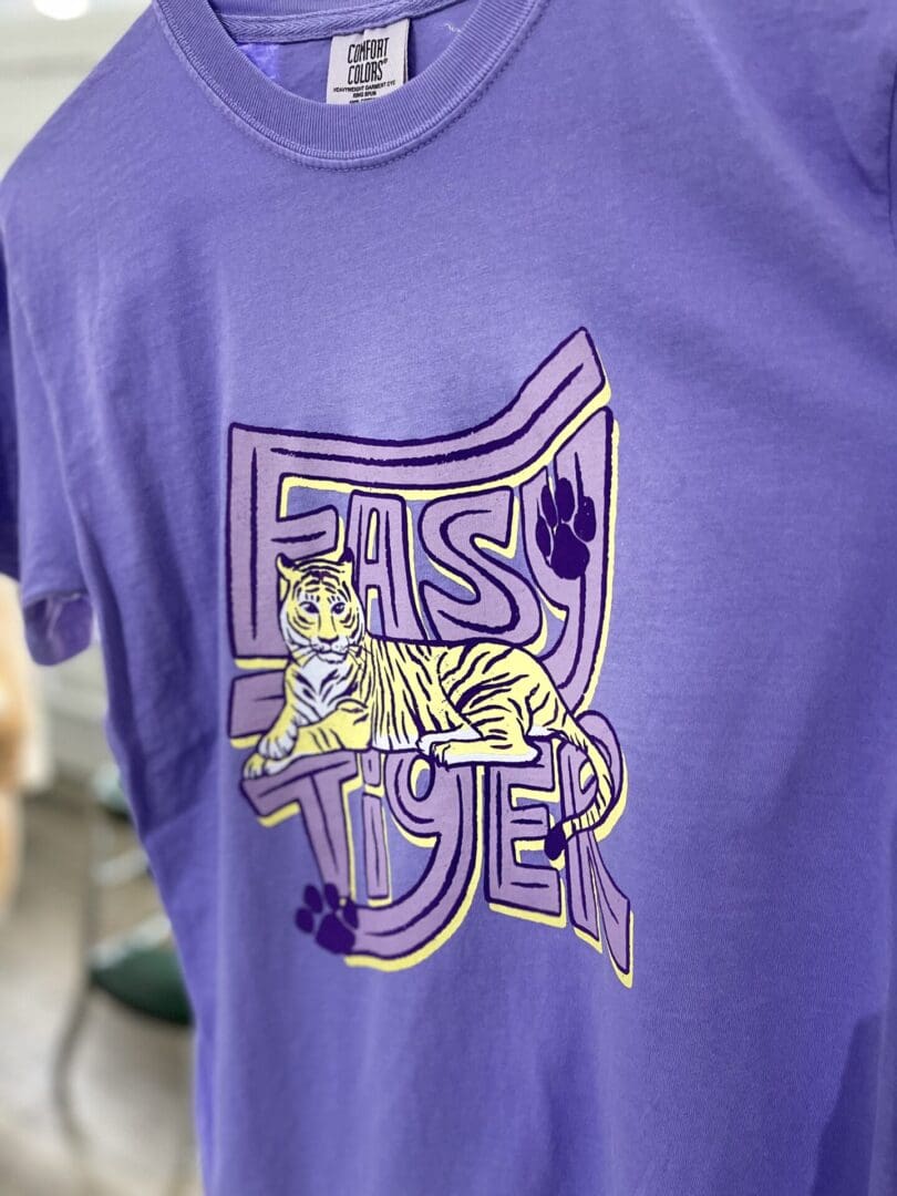 A purple shirt with a cat on it