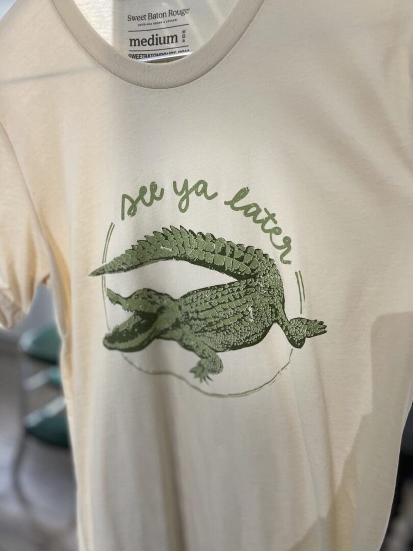 A close up of the front of a shirt with an alligator on it