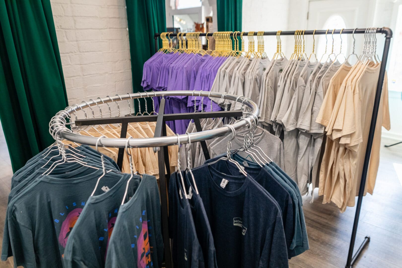 A rack of clothes and shirts in a store.