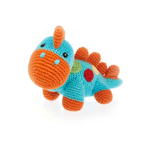 Crocheted dinosaur toy with colorful spots.