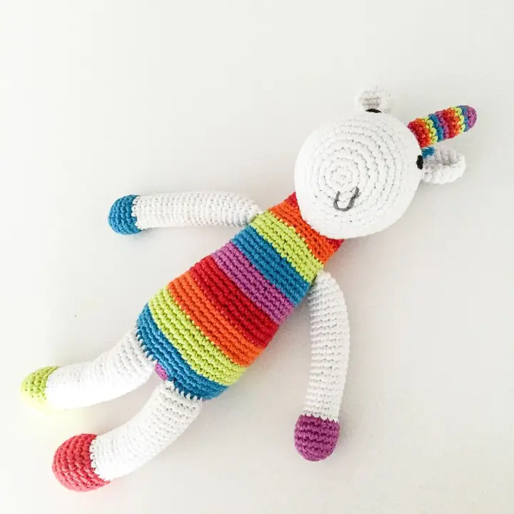 Rainbow striped crocheted unicorn toy.