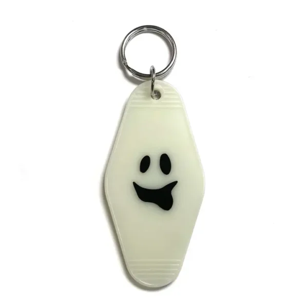 Ghost-shaped key chain with smiling face.