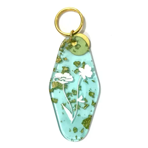 Blue key chain with gold leaf and flowers.