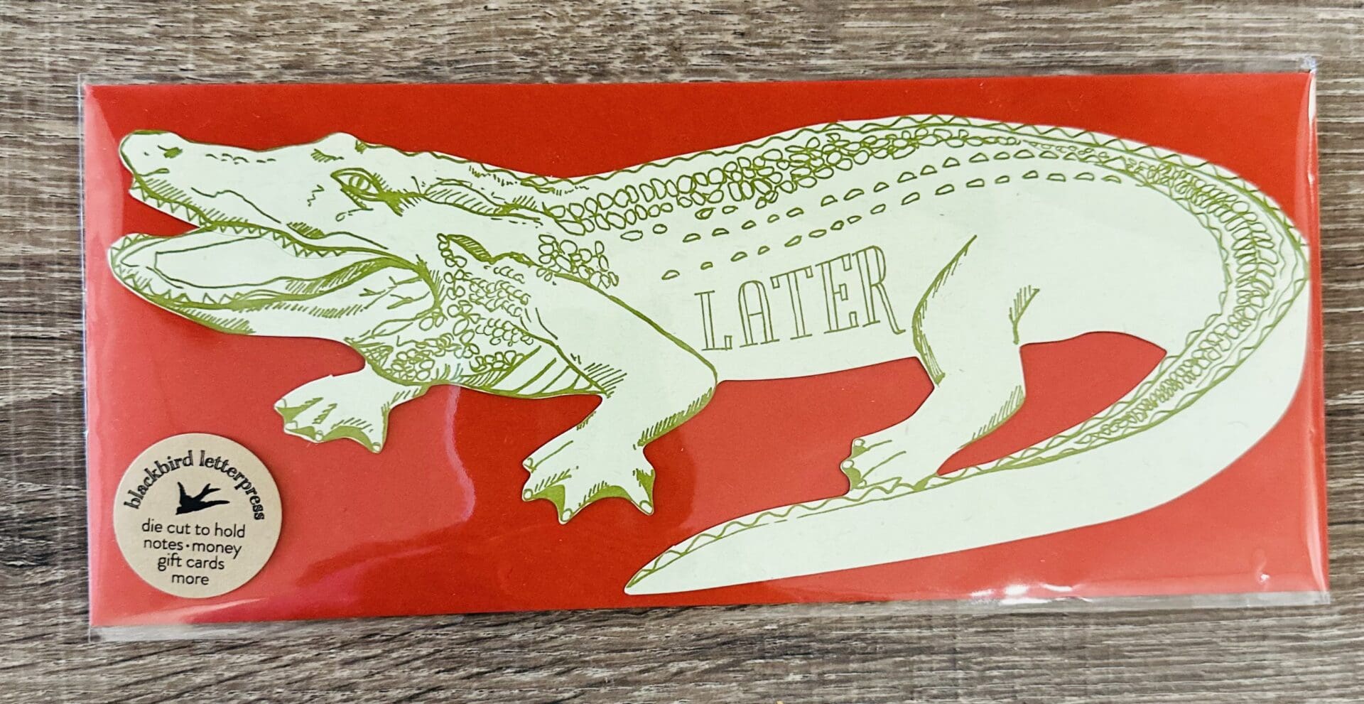 Green alligator card with "LATER" written on it.