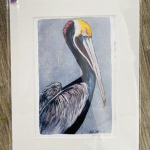 Framed watercolor painting of a pelican.