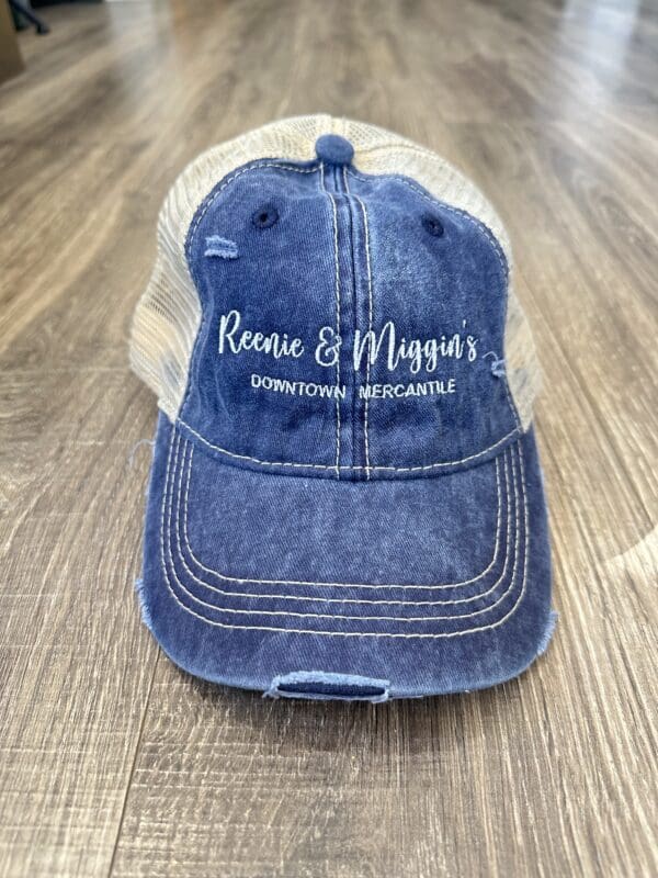 Blue denim trucker hat with "Reenie & Miggin's" logo.