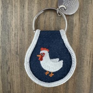 Keychain with embroidered white chicken.