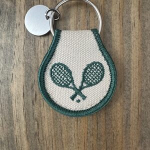 White and green tennis racket keychain.